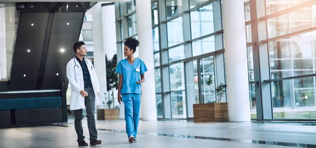 Medical Practitioners Having a Conversation in a Hospital